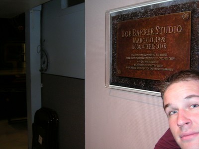 Close-up of a person next to a plaque commemorating the Bob Barker Studio and its 500th episode on March 11, 1998.