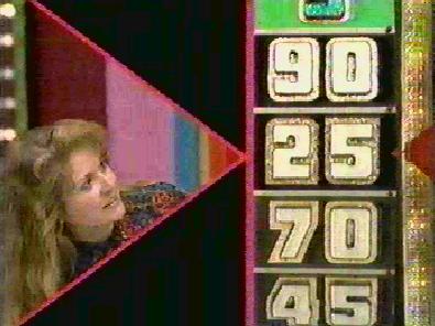 A contestant on The Price is Right looking at the Big Wheel display showing the numbers 90, 25, 70, and 45.