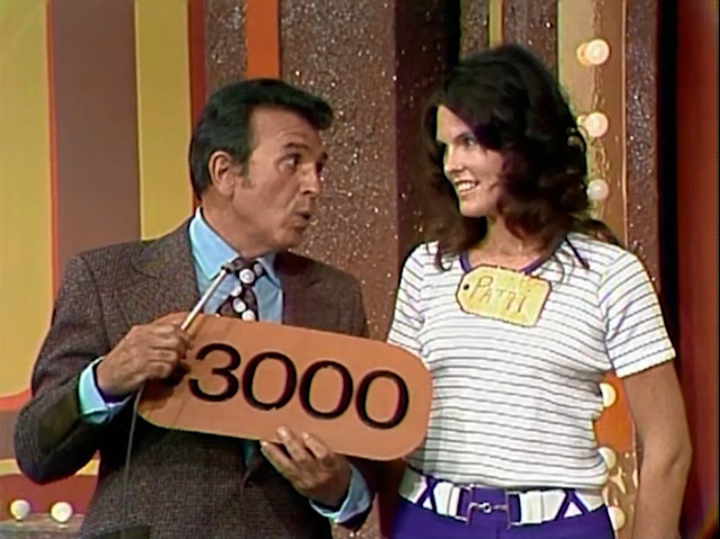 A contestant named Patti stands next to Dennis James, holding a sign displaying the price 00.