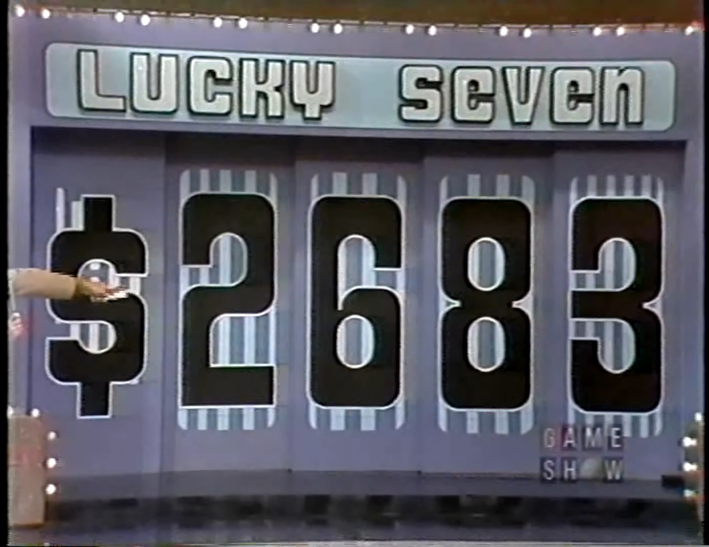 Display board for the game 'Lucky Seven' featuring the price 83 in large digits.