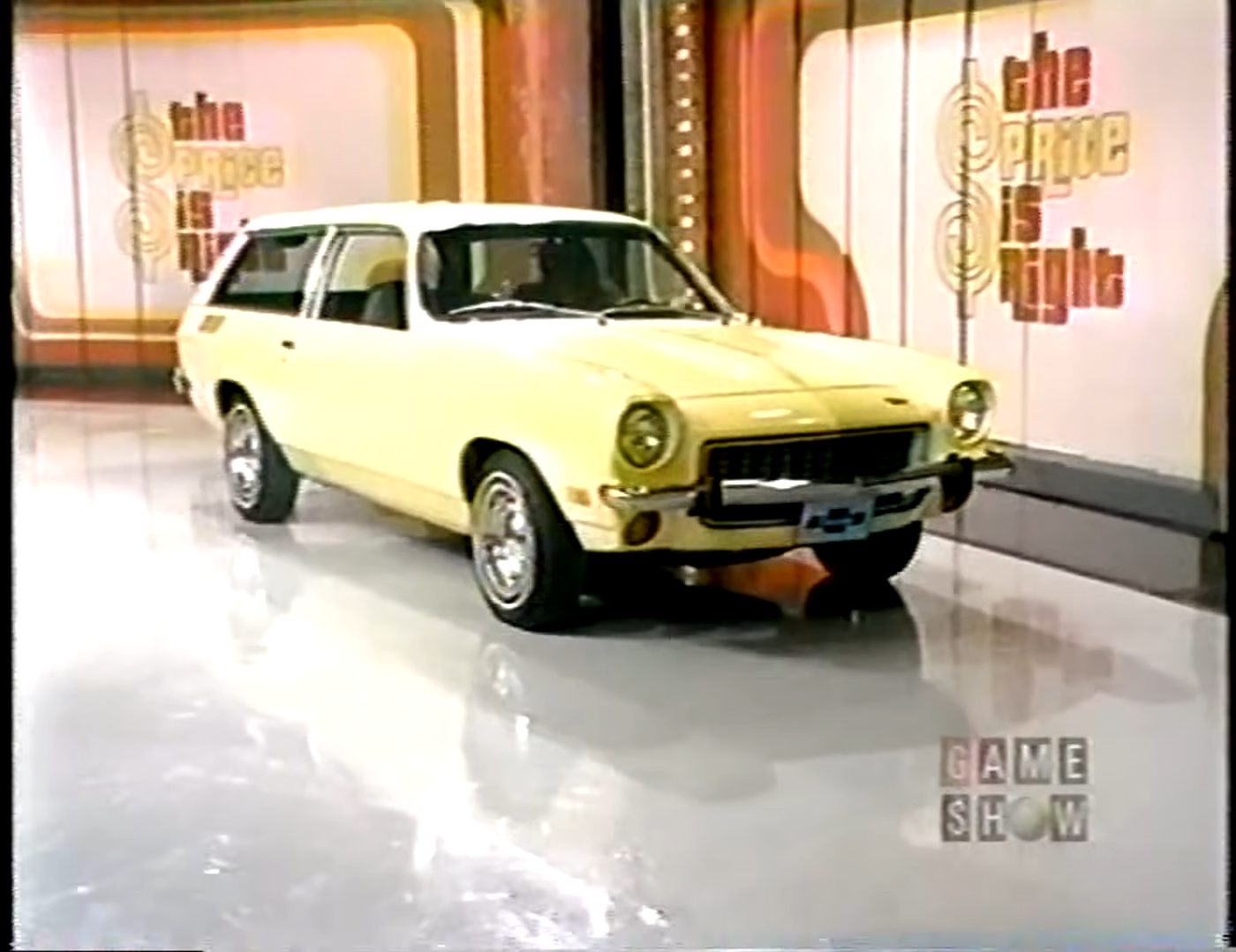 A vintage yellow Chevy Vega displayed on stage with 'The Price is Right' logo in the background.