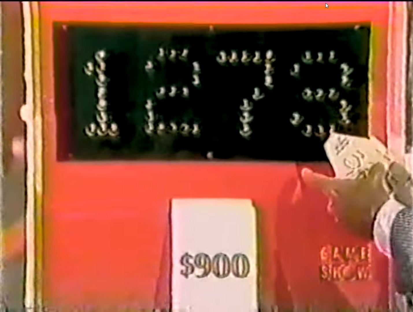 Display showing a bid of 0 for the Card Game on a game show, with a contestant holding a card.