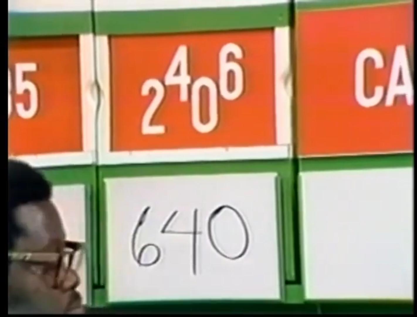A game board displaying the prices , 06, and a guess of 0, with a contestant partially visible on the left.