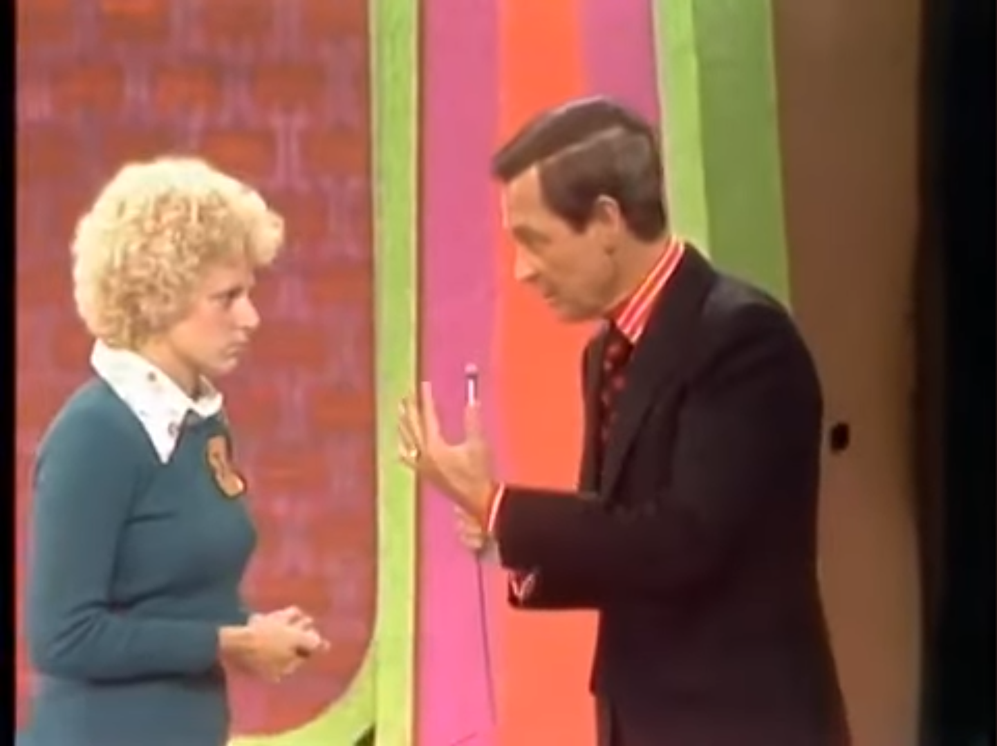 A tense moment between host Bob Barker and a contestant on a game show, with colorful backgrounds in the scene.