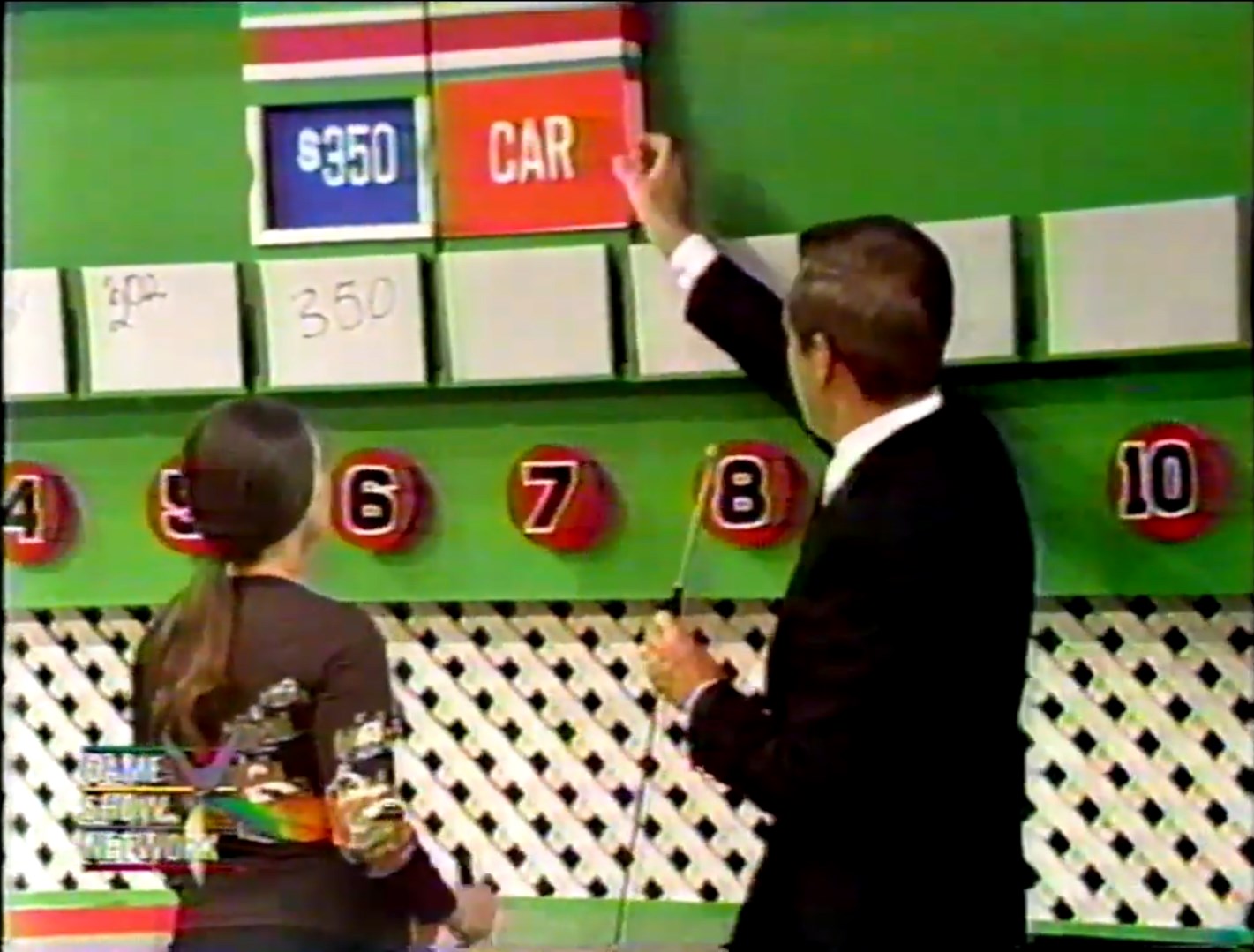 A contestant participates in the 'Ten Chances' game on The Price Is Right, with the host revealing a card indicating a price of 0 and a car prize.