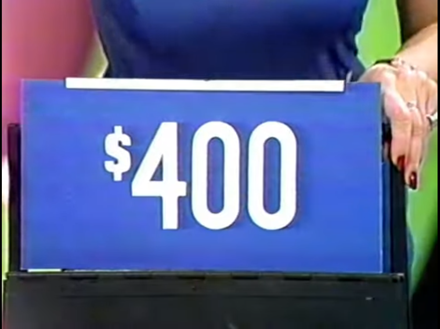 0 prize displayed on a blue board held by a contestant