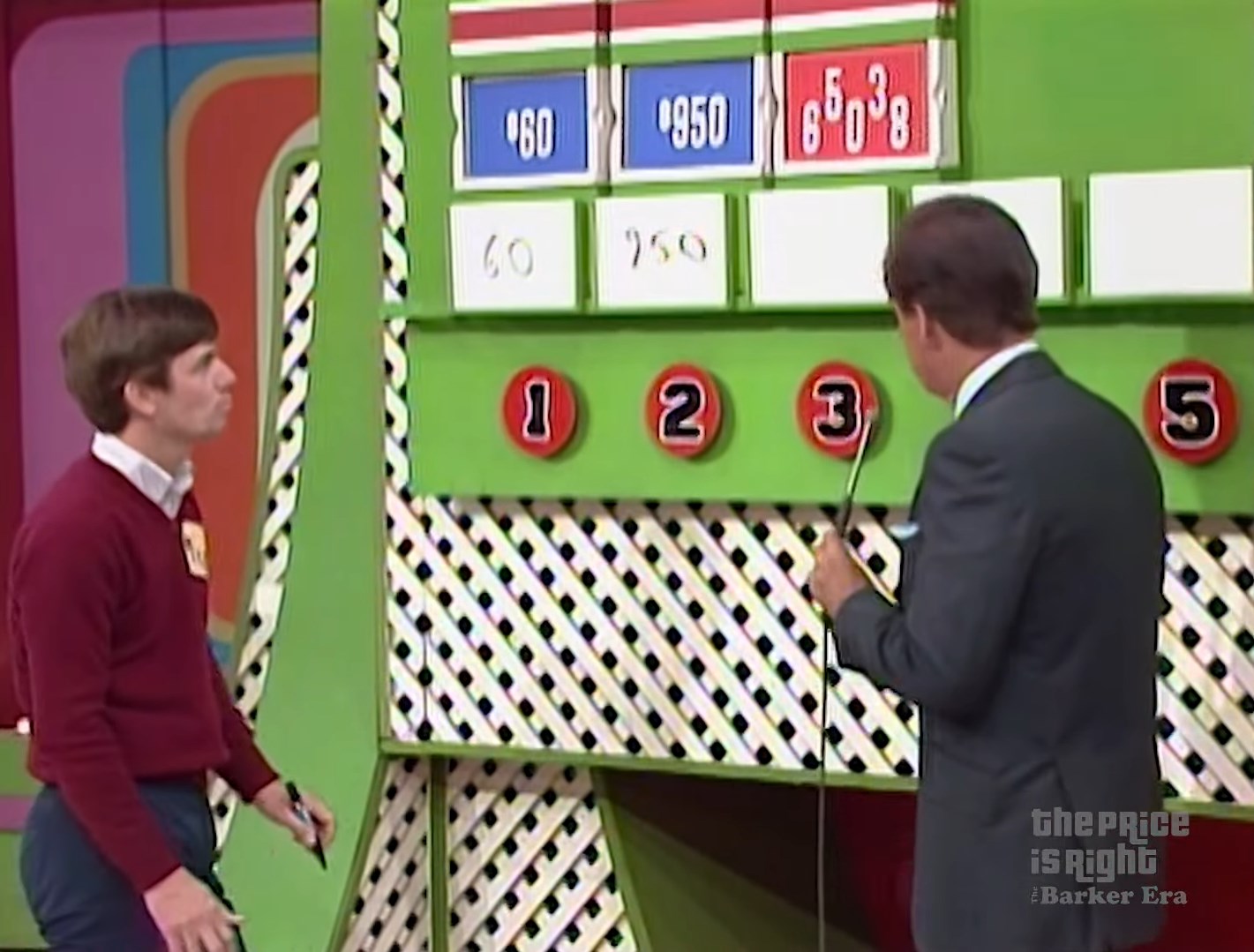 Contestant deliberates while host points at price options on the game board for the 'Ten Chances' game on The Price is Right.