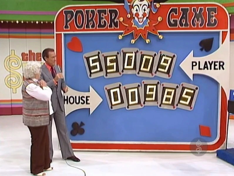 A game host and a contestant stand beside the Poker Game board, displaying the player's poker hand as 55009 and the house's hand as 00985.