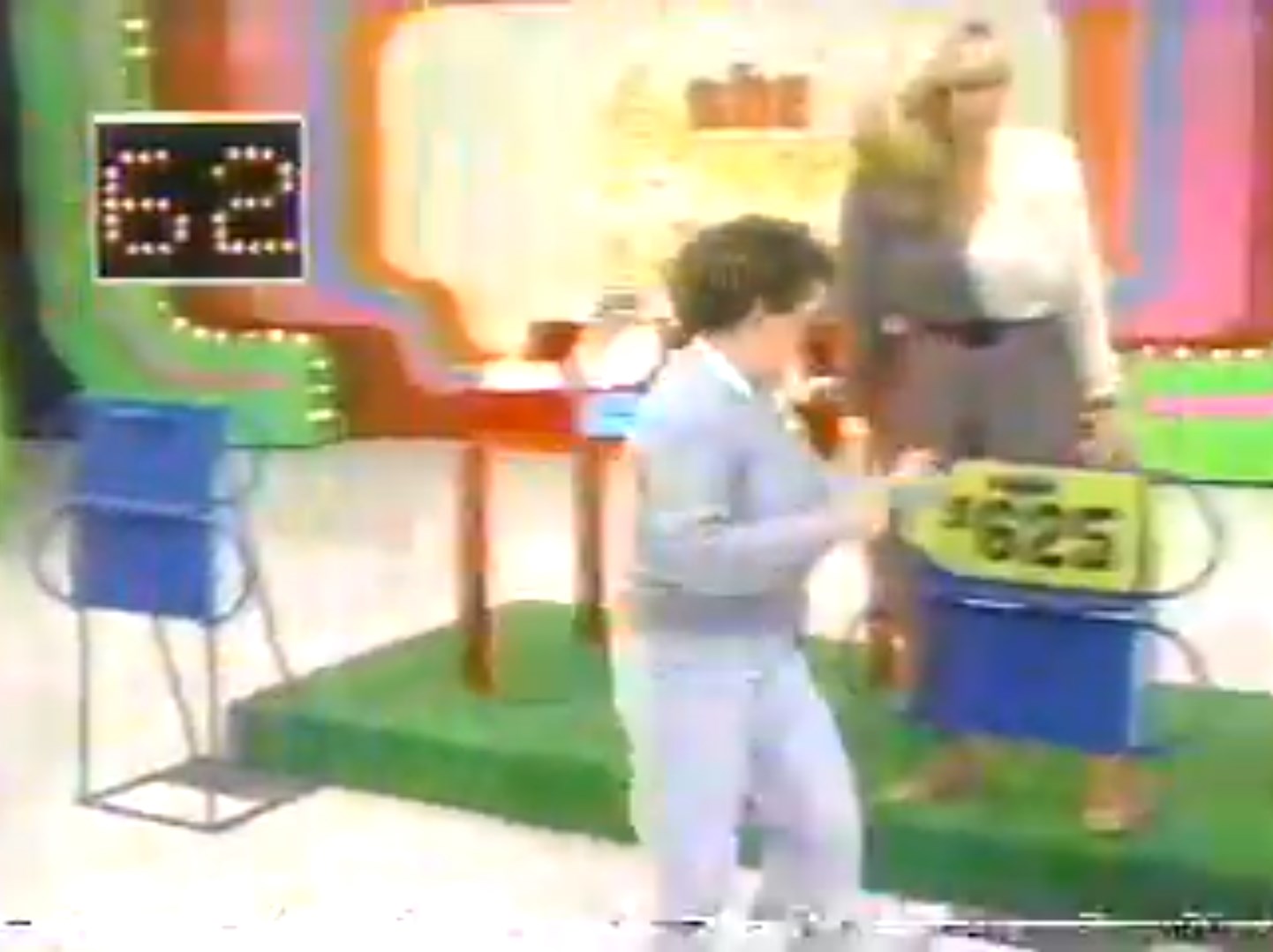 A contestant runs around during the Race Game on The Price is Right, with a timer showing 62 seconds and a prize displayed on a yellow price tag.