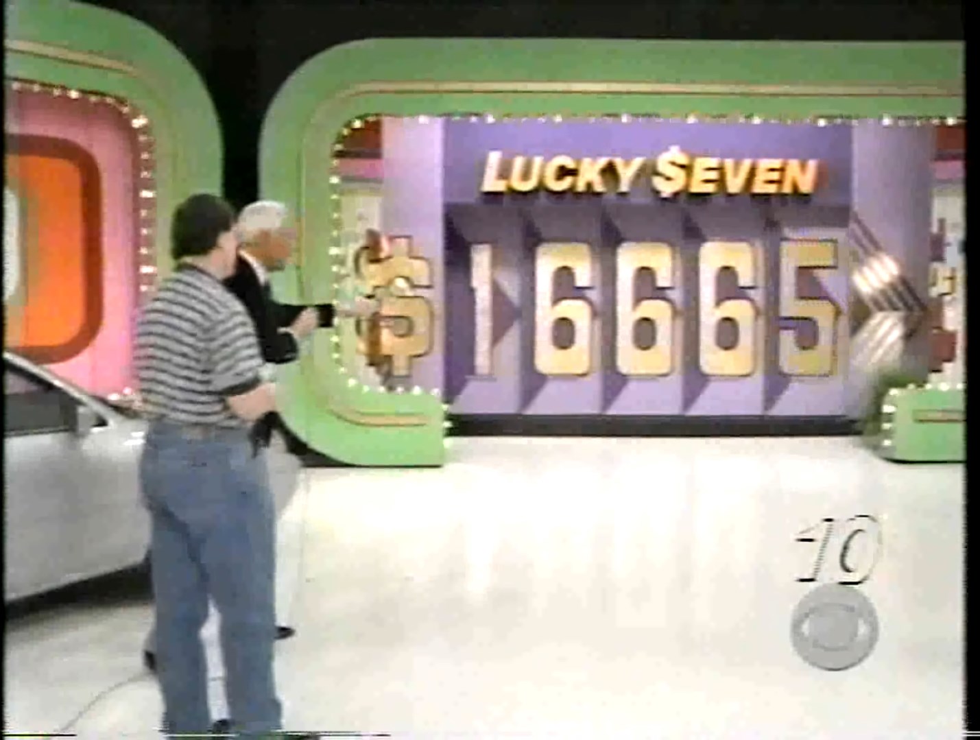 A game show set featuring the words 'LUCKY $EVEN' with a price display showing '665', alongside a host and a contestant.