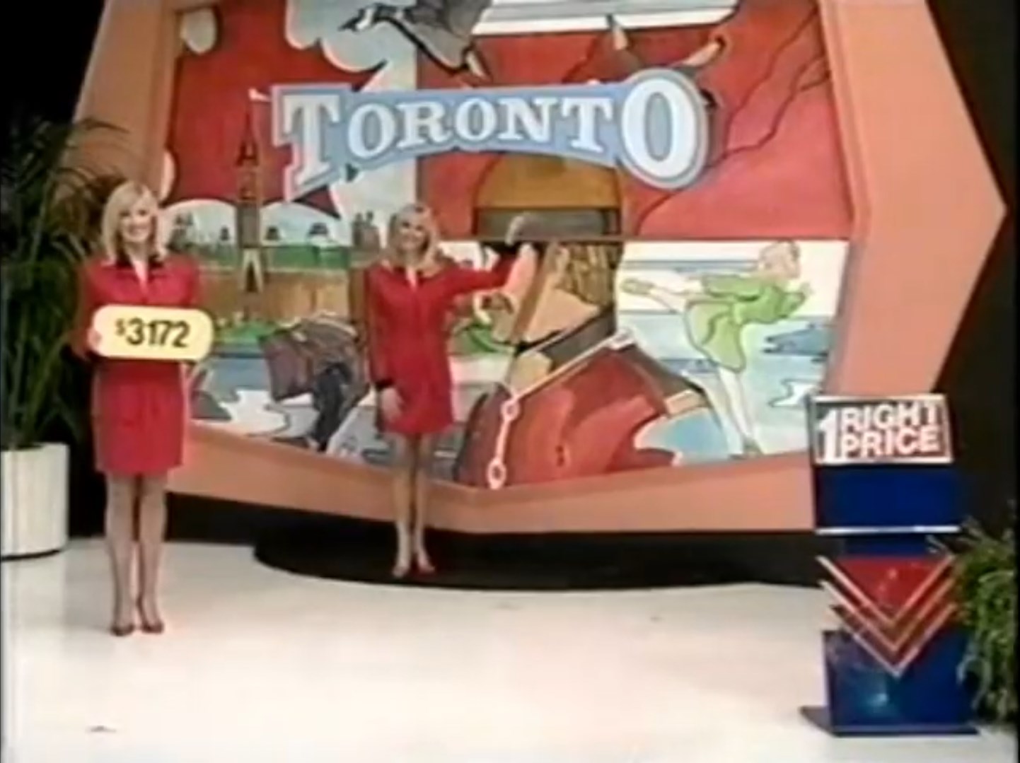 Two models in red outfits stand next to a colorful backdrop featuring the word 'Toronto' and various images related to the city. One model holds a price tag reading '72', while the other points towards the backdrop.