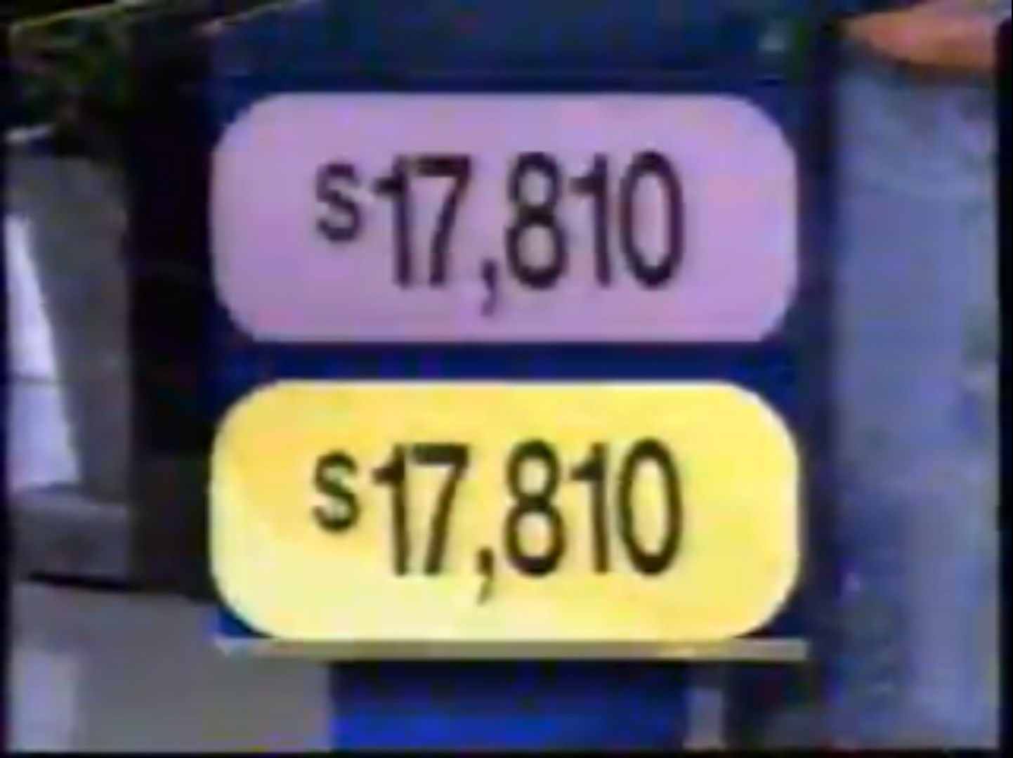 Image showing two price tags labeled ,810 in purple and yellow for a game show segment.