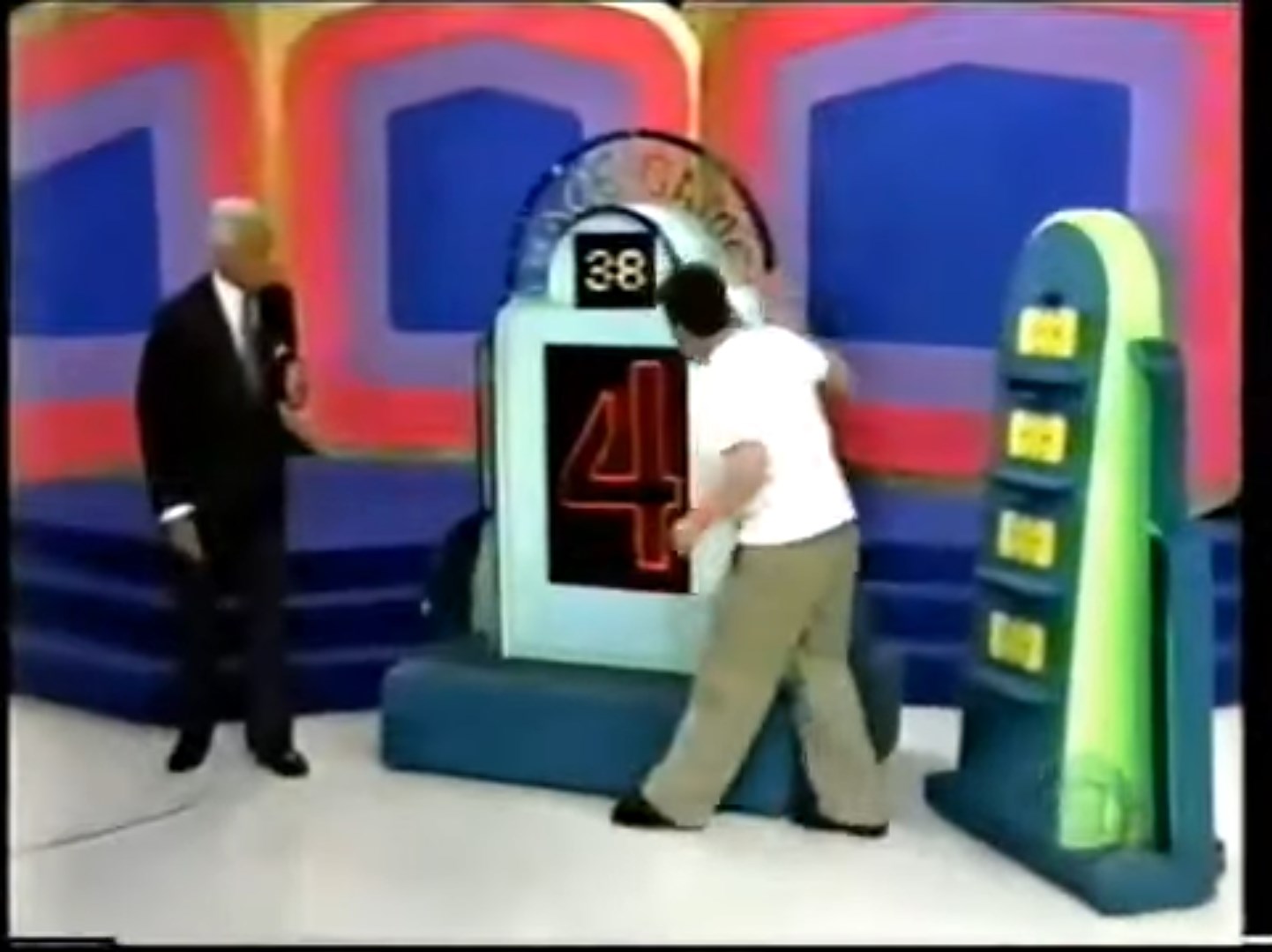 Contestant interacts with the Race Game display as the host observes, with a countdown timer showing 38 seconds remaining.