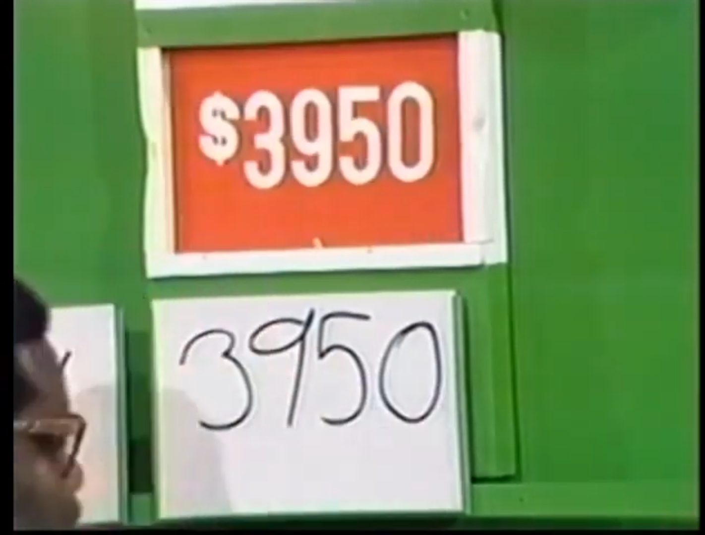 Contestant's guess of 50 displayed on a card next to the actual price of 50 in a game show setting.