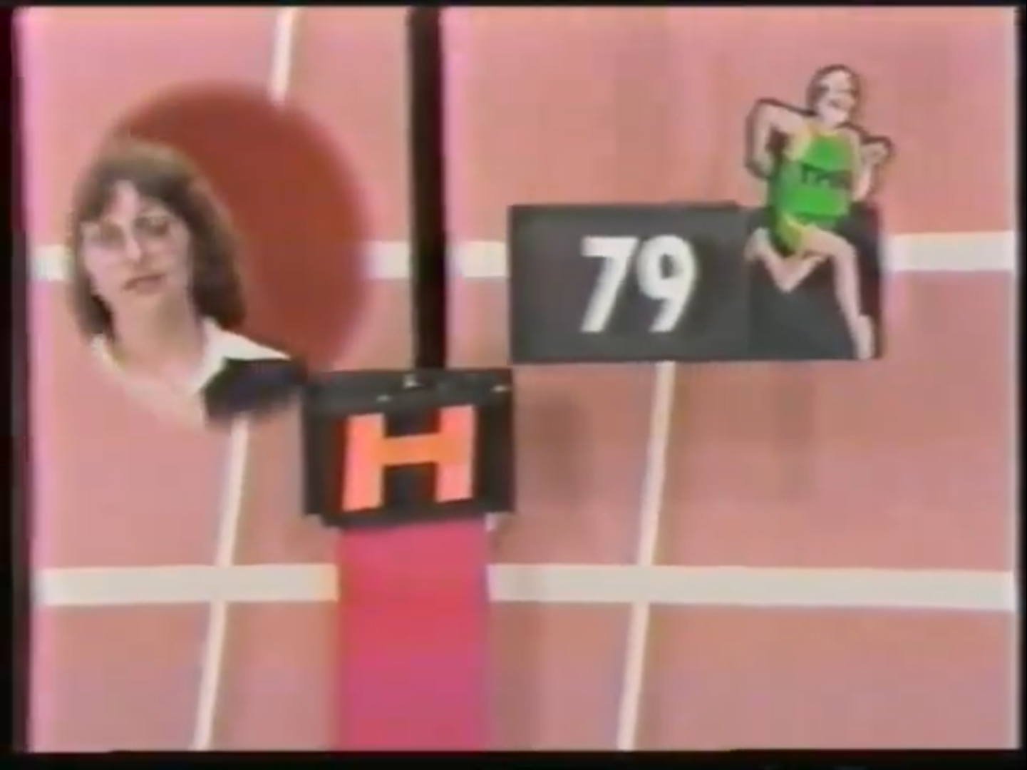 A contestant on The Price is Right stands next to a scoreboard displaying the letter 'H' and the number '79', as a cartoon runner moves above the score.