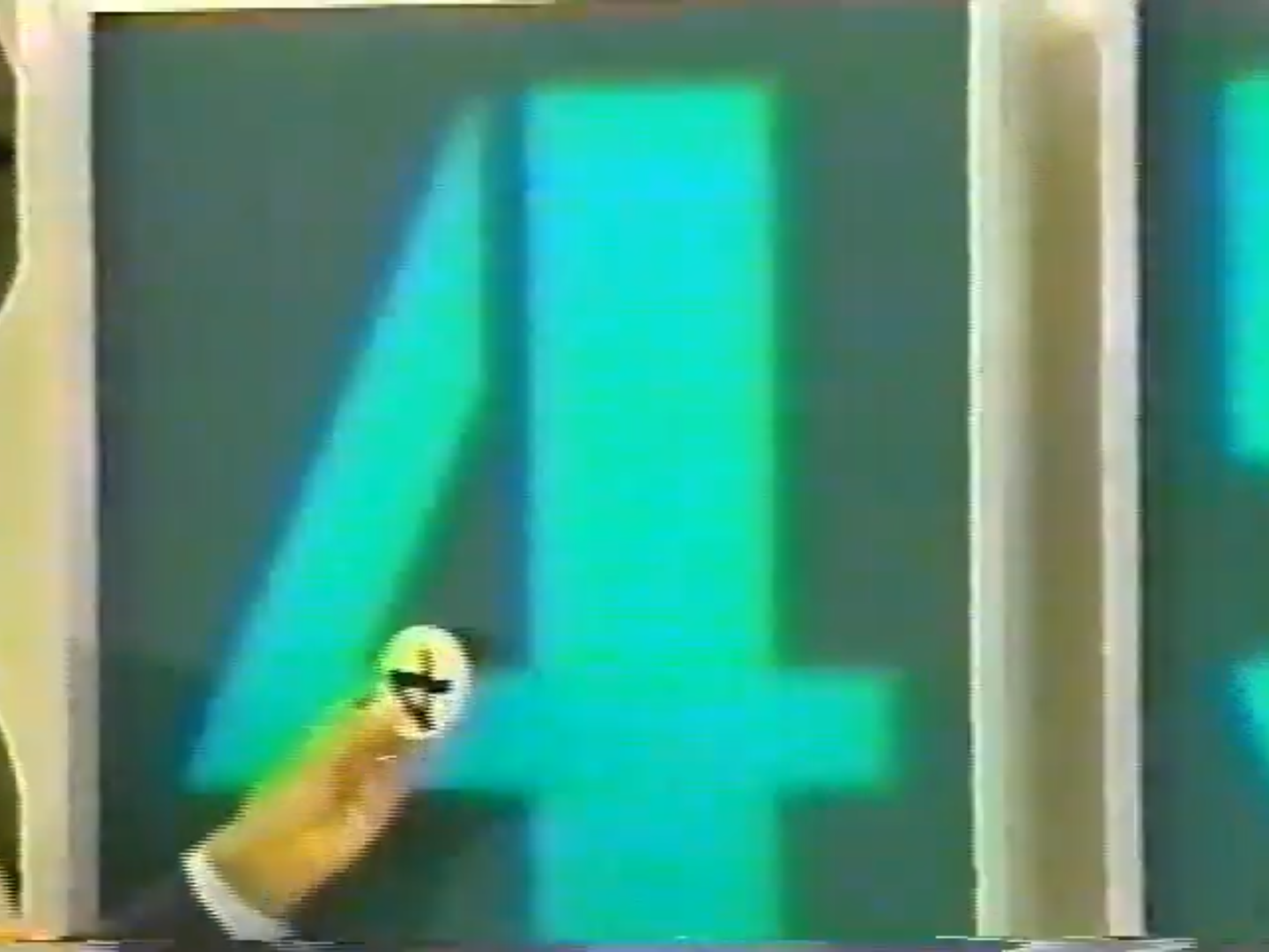 A contestant points to the number 4 displayed on a game board during the Three Strikes game on The Price is Right.