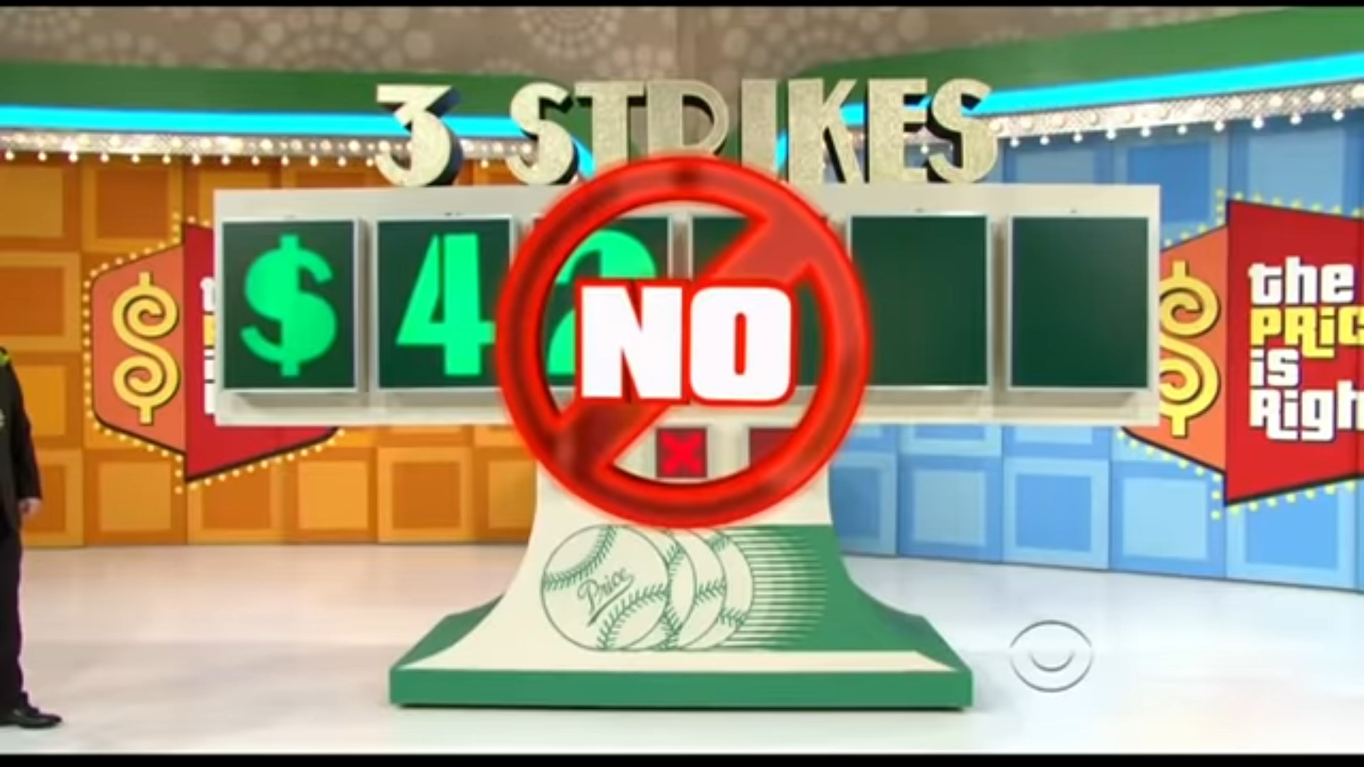 A game setup for 'Three Strikes' on The Price is Right, featuring a display with the numbers 4 and 2 shown in green, alongside a 'NO' sign and a baseball graphic.