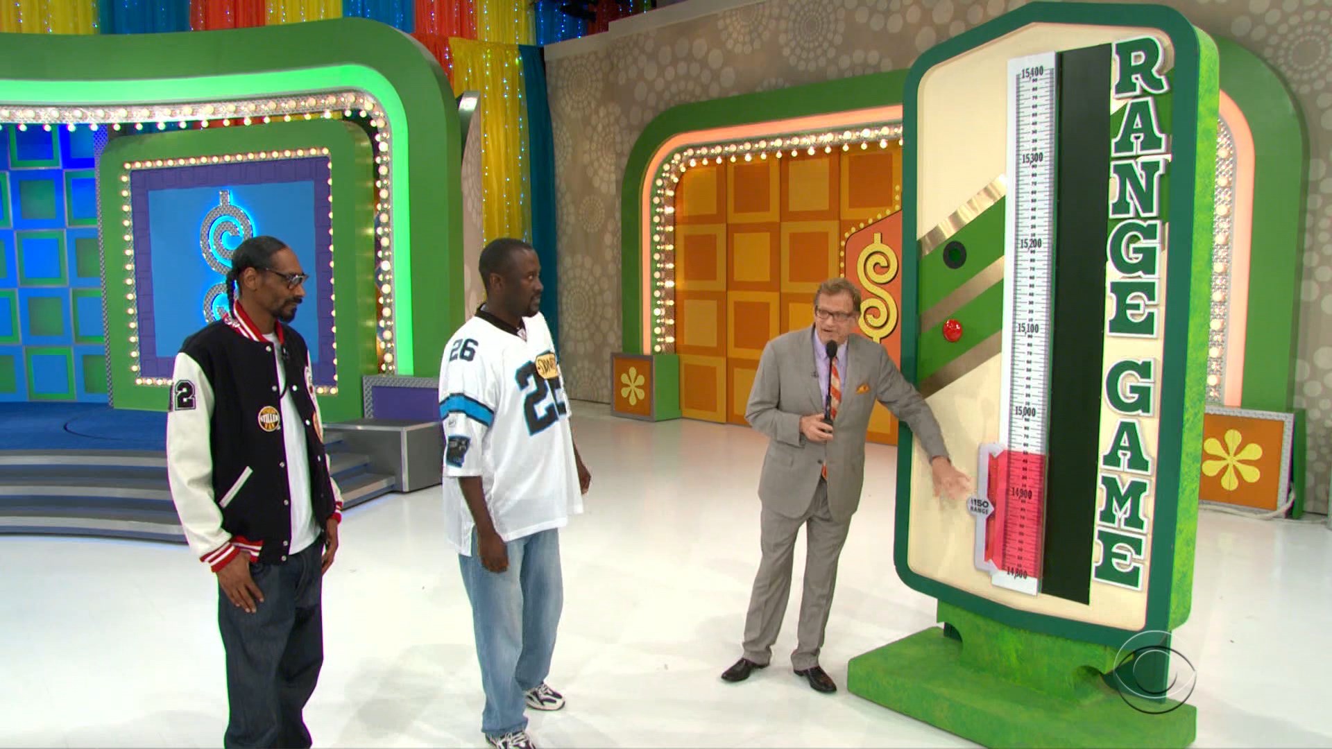 Snoop Dogg participate in the Range Game on The Price is Right, with a visible scale indicating a range of prices and the host explaining the rules.
