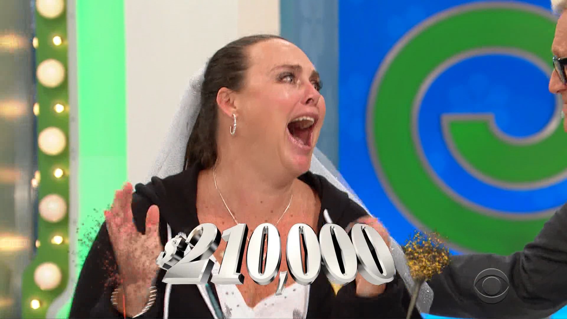 A contestant celebrating after winning 0,000 on The Price is Right, showing excitement and joy.