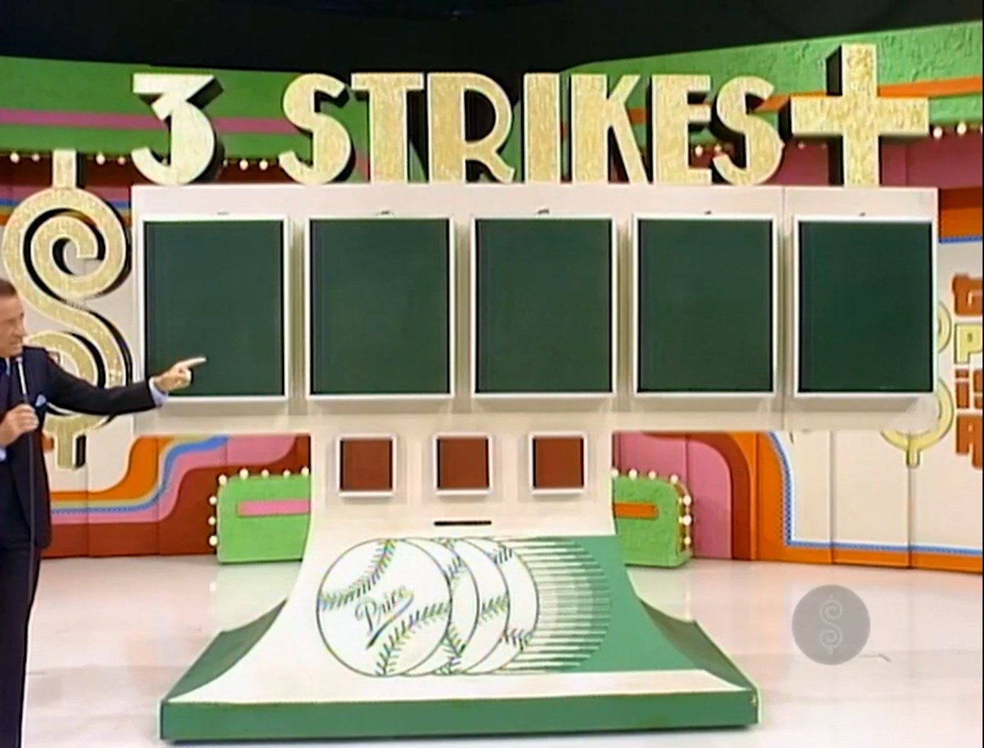A host points at the scoreboard for the game '3 Strikes' featuring empty chalkboards and a baseball-themed design.