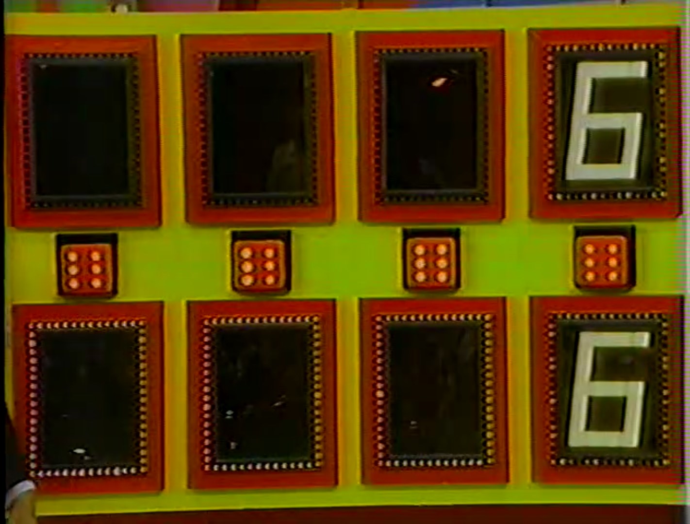 Game board for Dice Game featuring hidden slots for numbers, oversized dice, and a prominent display of the number 6.