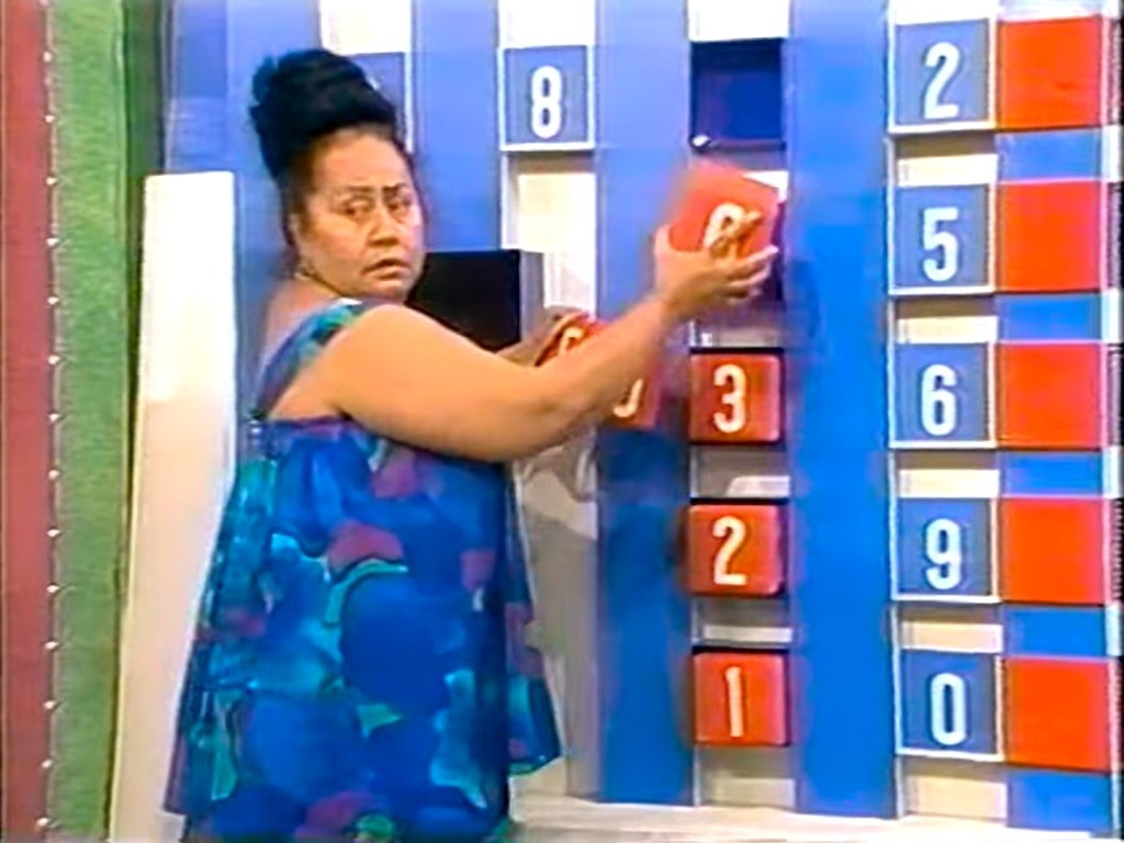 Contestant placing numbered blocks on the Switcheroo game board during The Price is Right.