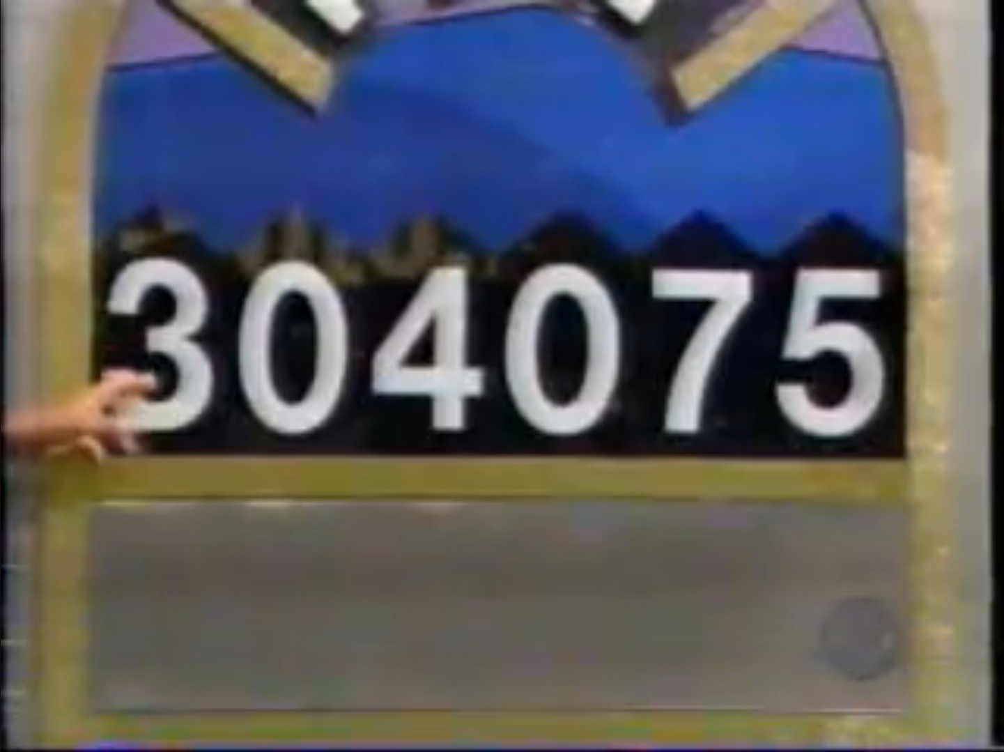 Contestant pointing at the numbers 304075 displayed on the Squeeze Play game board.