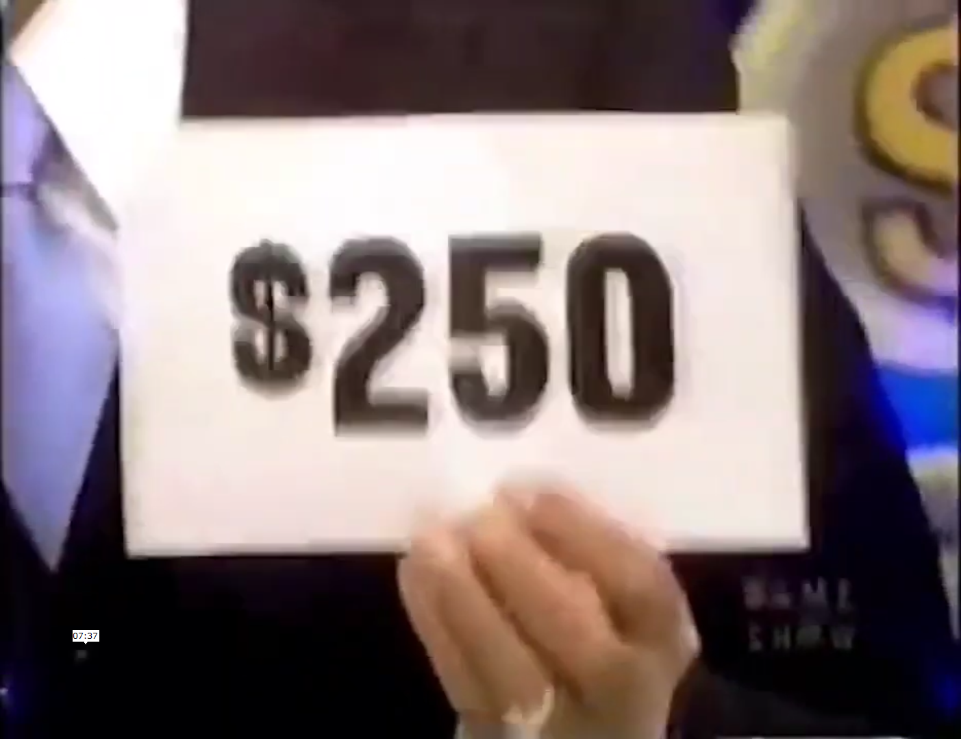 0 sign being held by a contestant on a game show.