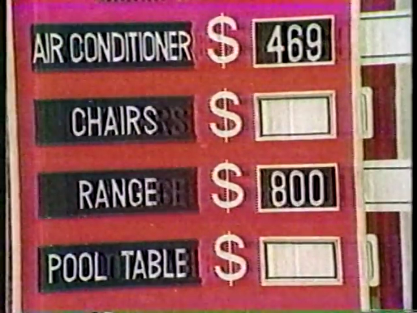 Display of four prizes from the game Take Two, including an air conditioner priced at 9, chairs, a range at 0, and a pool table.