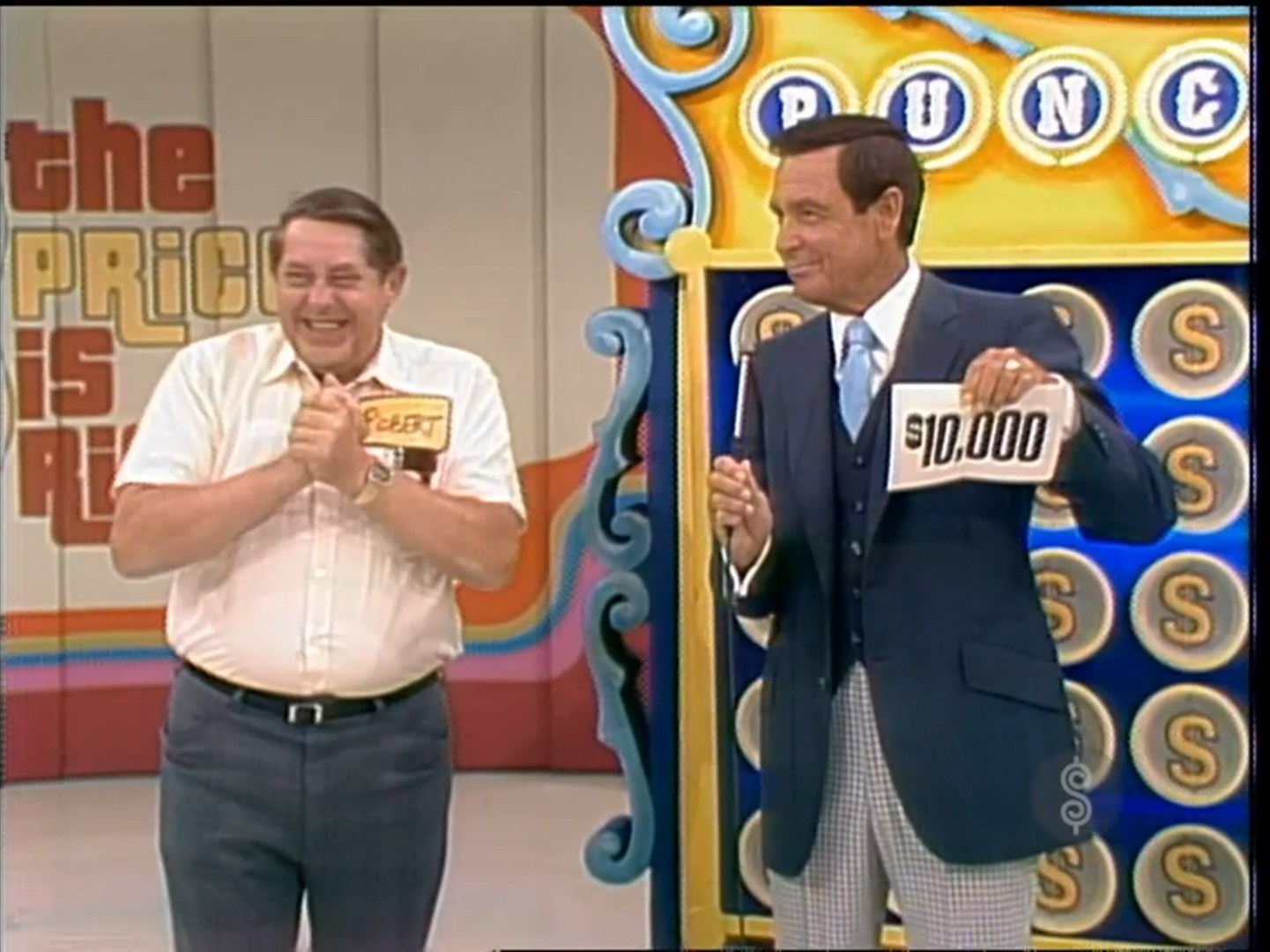 A contestant named Gilbert looks excited as he stands next to the host, who holds a sign showing ,000, during a game of Punch a Bunch on The Price is Right.