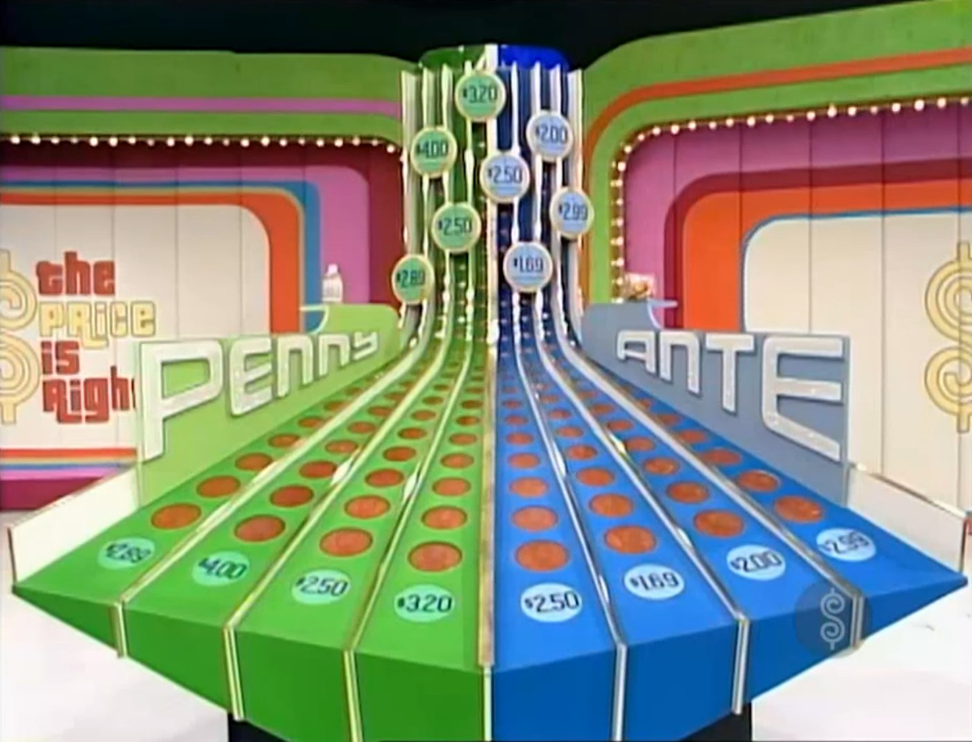 Colorful set design of the Penny Ante game on The Price is Right, featuring oversized price indicators and vibrant signage.