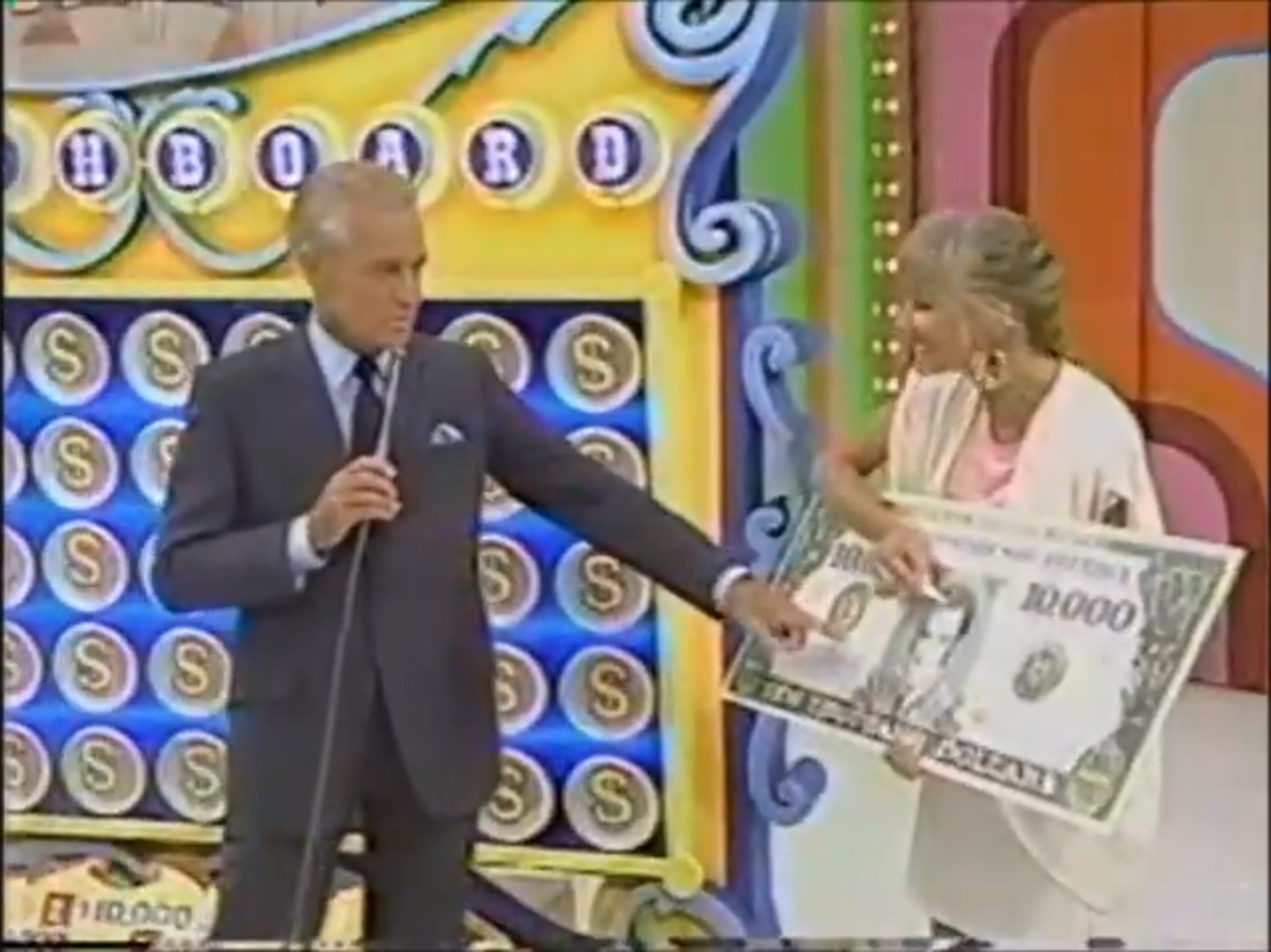 Janice Pennington colors in Bob Barker's hair on a giant novelty bill for ,000 to reflect that he has gone gray.