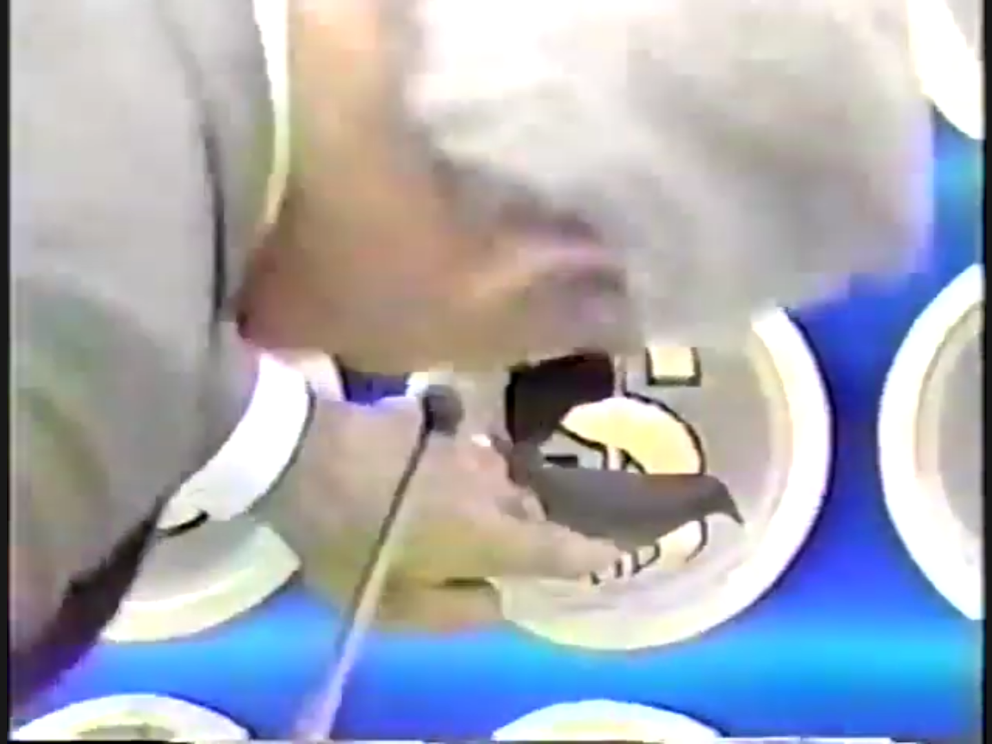 A contestant punches a hole on the Punch a Bunch board to reveal a cash prize.