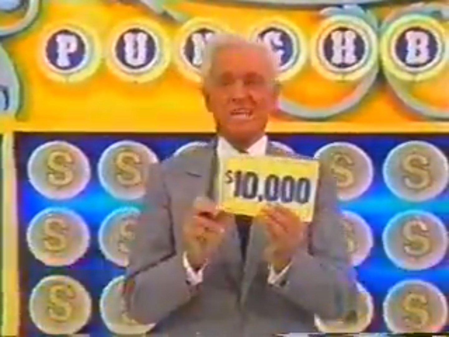 A game show host holds up a ,000 sign in front of a colorful punchboard during a segment of Punch a Bunch.