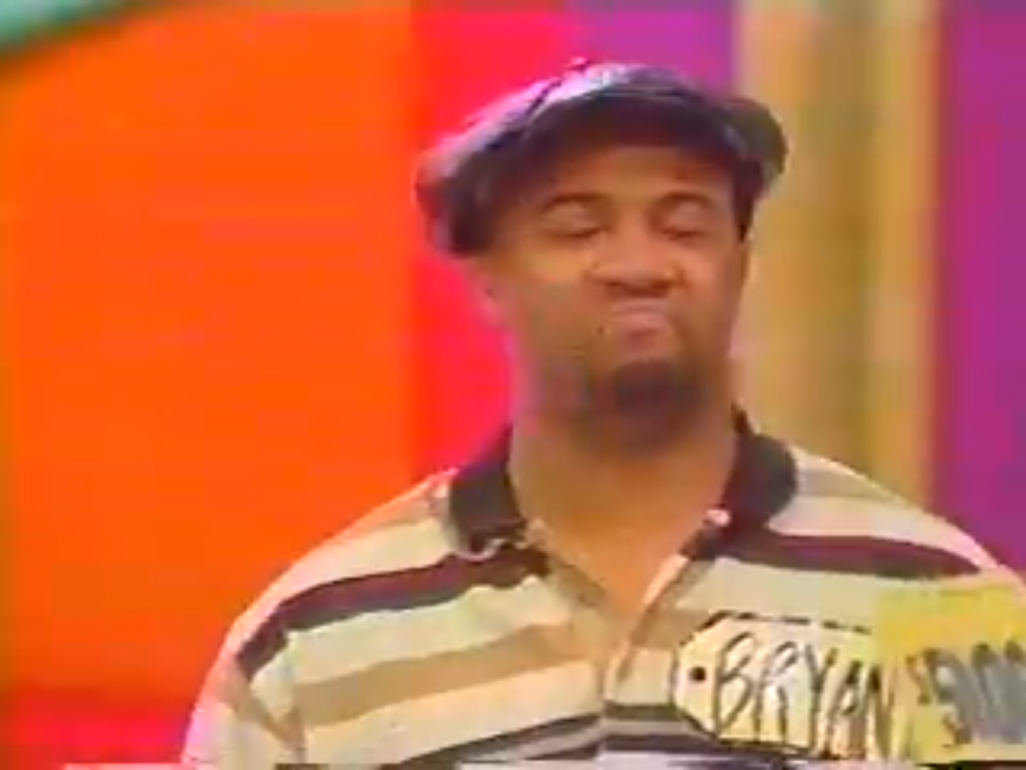 Contestant Bryan showing a facial expression of discontent while holding his name tag on The Price is Right.