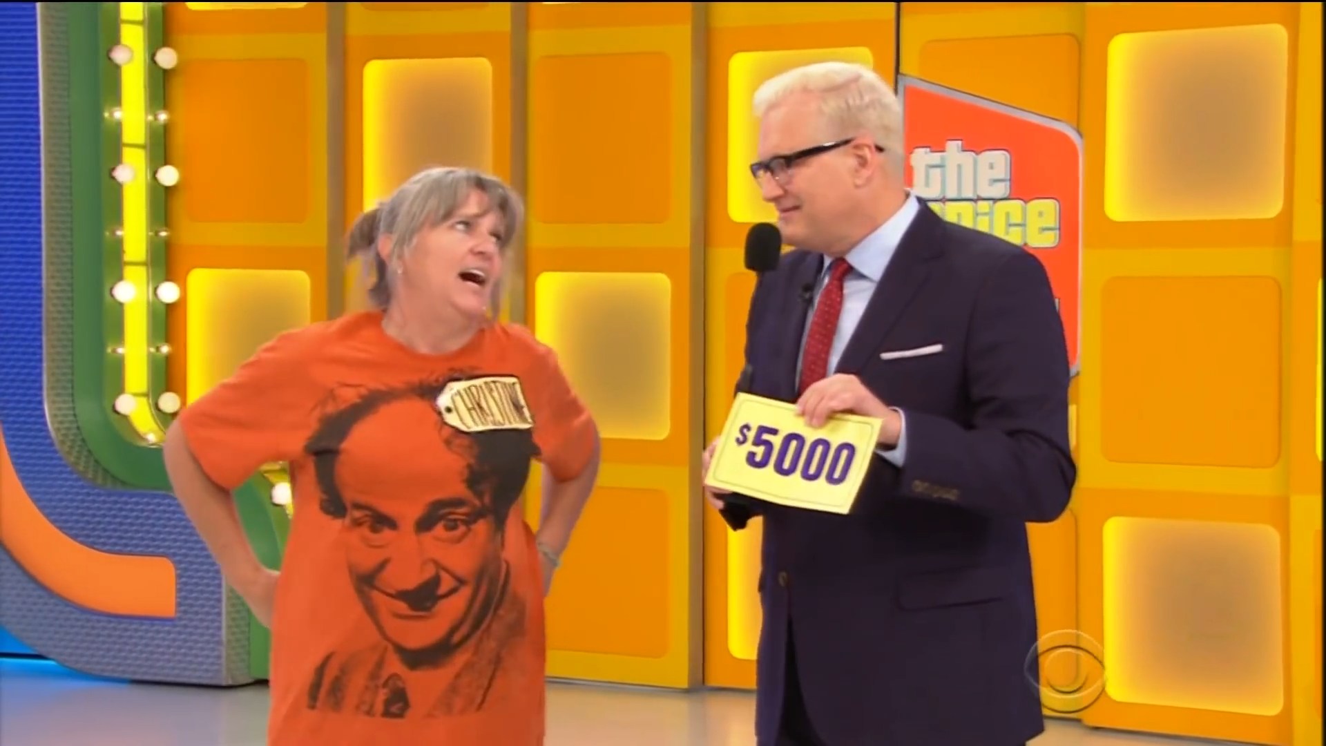 Contestant Christine expresses excitement while holding a ,000 prize on 'The Price is Right' set.