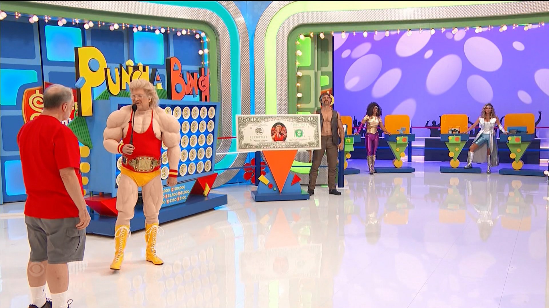Scene from 'Punch a Bunch' on The Price is Right featuring a muscular host and contestants standing by prize podiums with a large cash prize displayed.