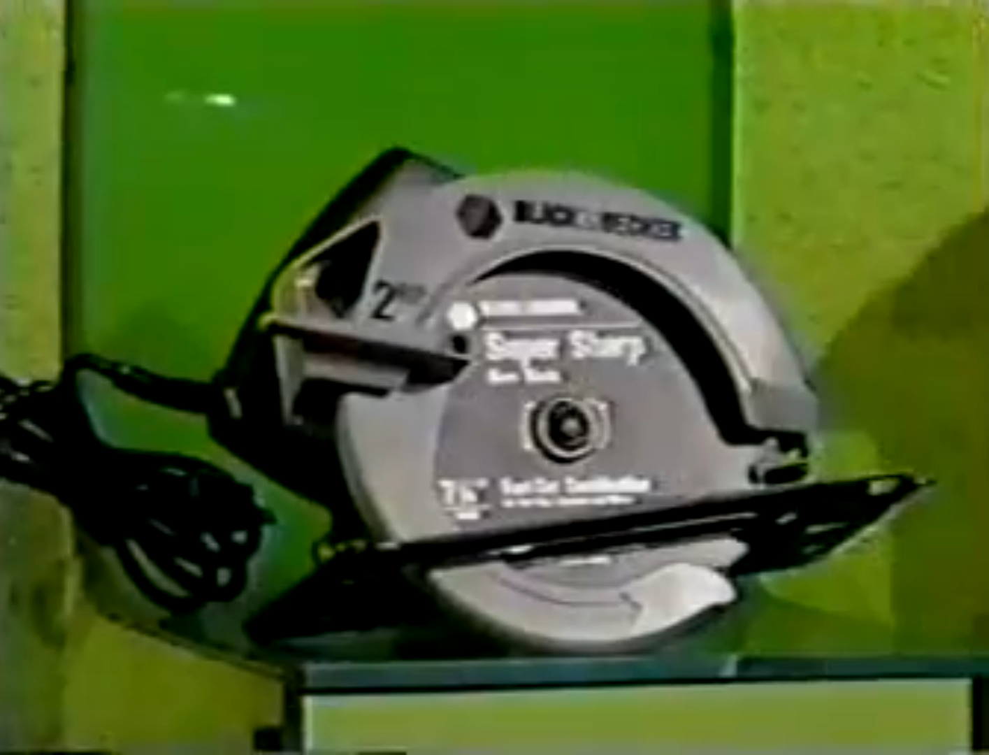A circular saw displayed on a green background, labeled 'Super Sharp' with a power cord attached.