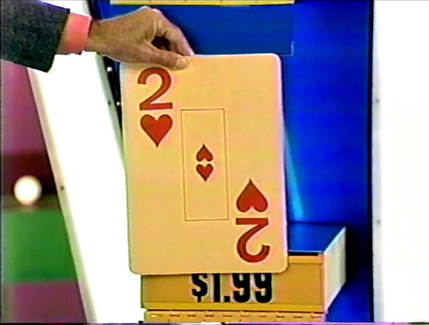 A hand showing a drawn card featuring a 2 of hearts next to a price tag displaying .99.