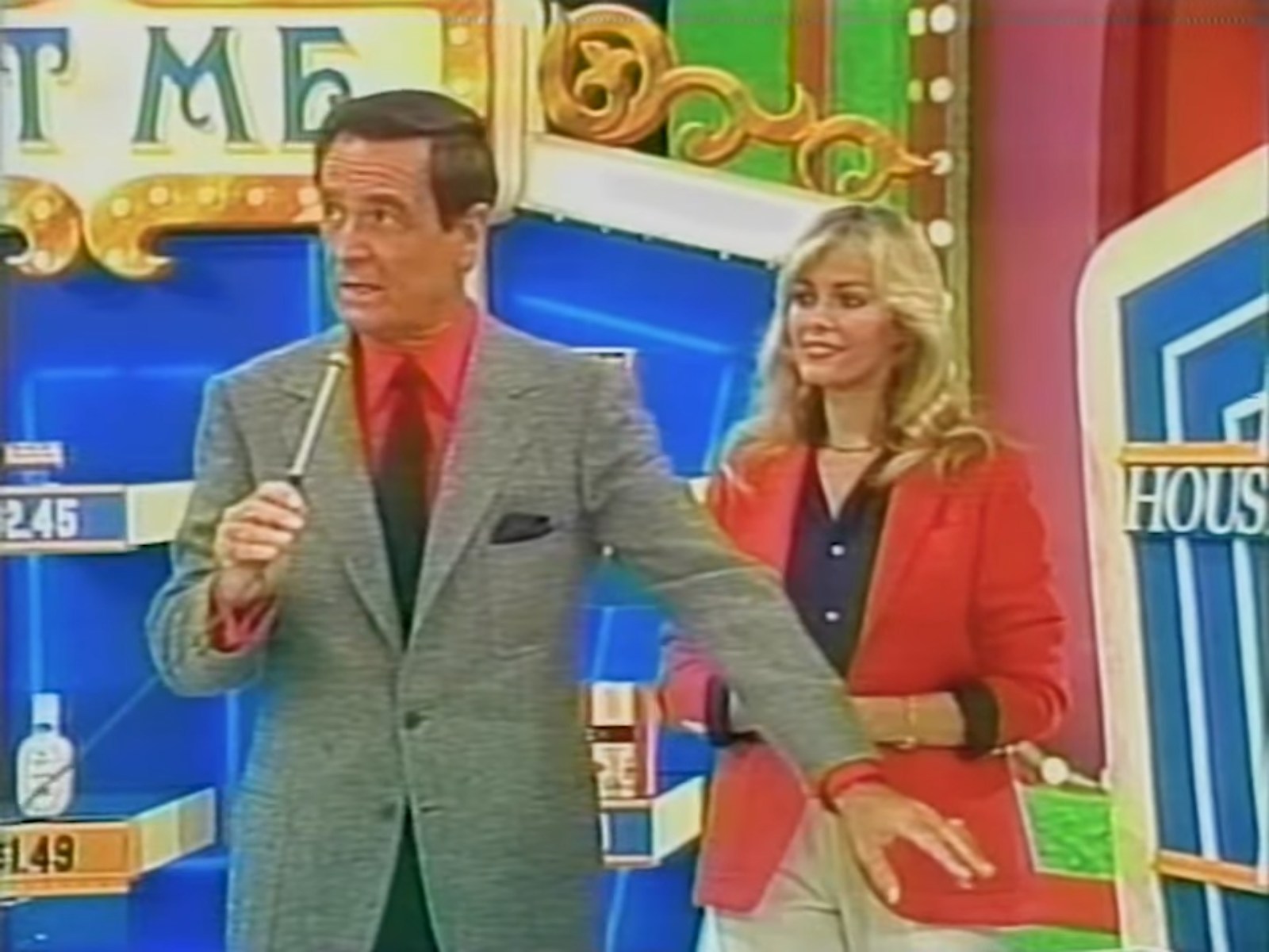 Bob Barker presenting the 'Hit Me' game on The Price is Right, with a model standing beside him and grocery products displayed in the background.