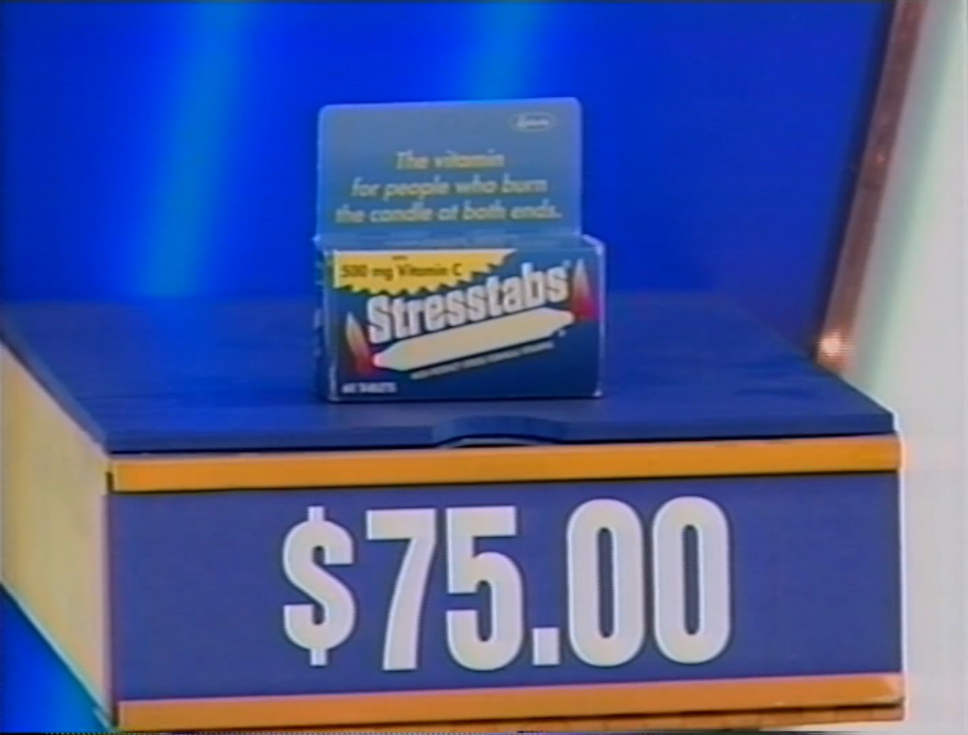 A box of Stresstabs vitamin supplements presented on a game show table, with a displayed price of .00.