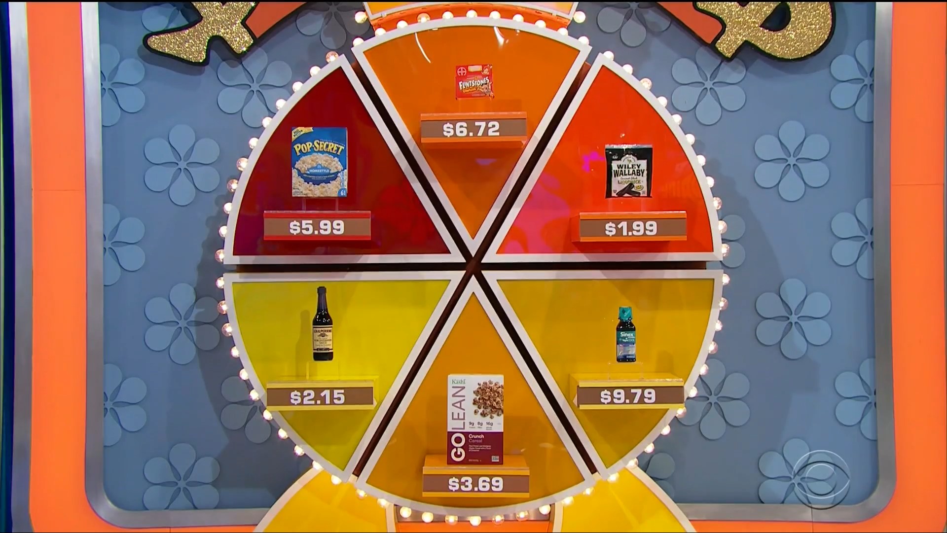 A circular game board showing six grocery products with their prices displayed, part of the pricing game 'Now or Then'.