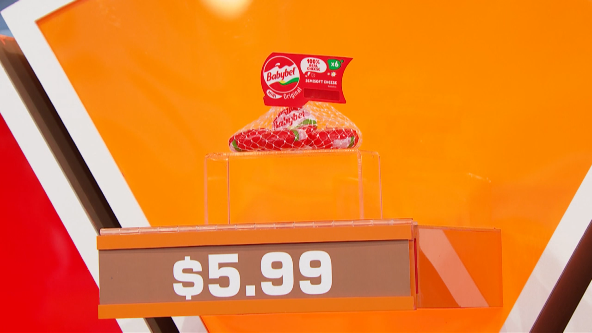 A pack of Babybel cheese displayed on a stand with a price tag of .99 against a colorful background.