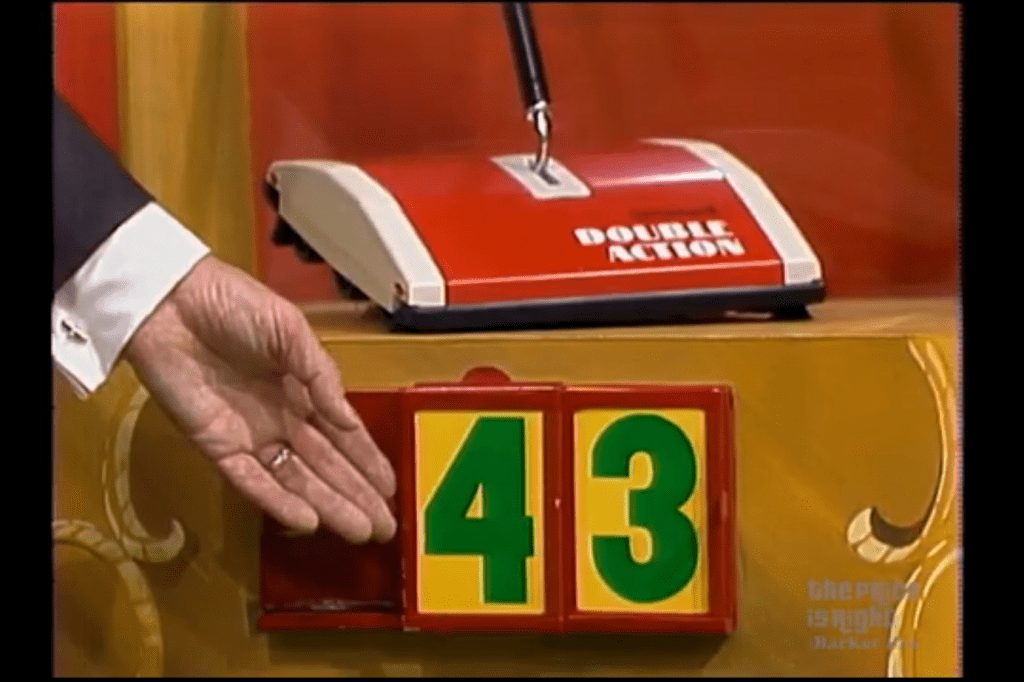 A hand points to the number 43 on a game display, with a red device labeled 'DOUBLE ACTION' in the background.
