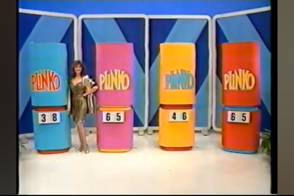 A model in a glamorous outfit stands beside colorful Plinko game columns with numbers displayed on them, showcasing the iconic game from The Price is Right.