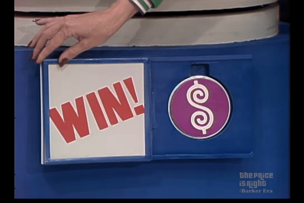 A hand reaching towards a sign that says 'WIN!' next to a circular Plinko Chip with a dollar sign on it, displayed on a blue surface.