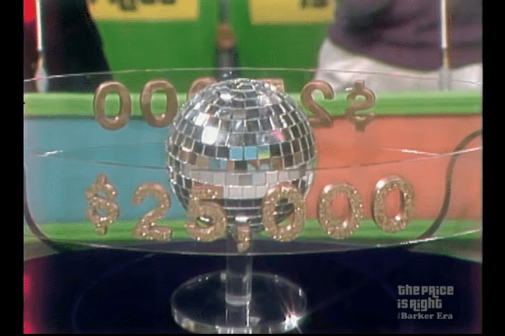 A disco ball descends from the Price is Right audience ceiling revealing that the contestant is playing for up to ,000 in cash.