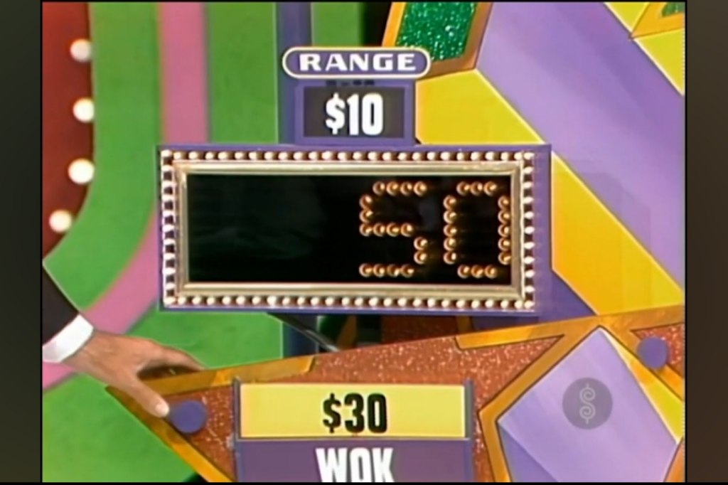 Display board showing a price guess of  with a range of  for the prize labeled 'WOK' worth .