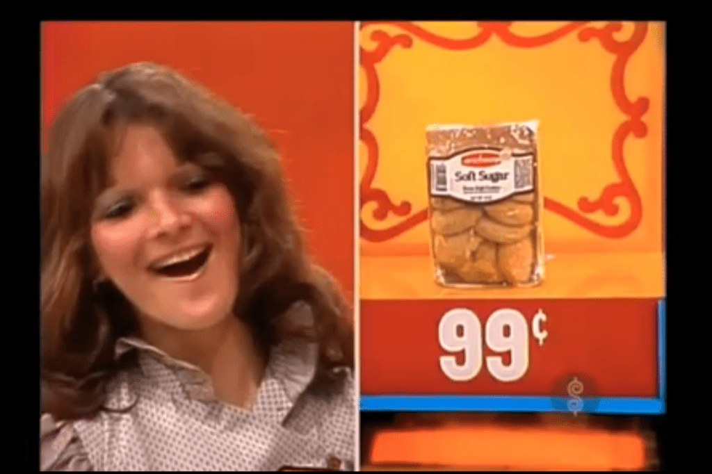 A contestant smiles with excitement while revealing a package of Soft Sugar cookies priced at 99 cents.