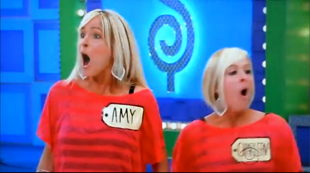 Two contestants express excitement while playing a game on a brightly colored set.